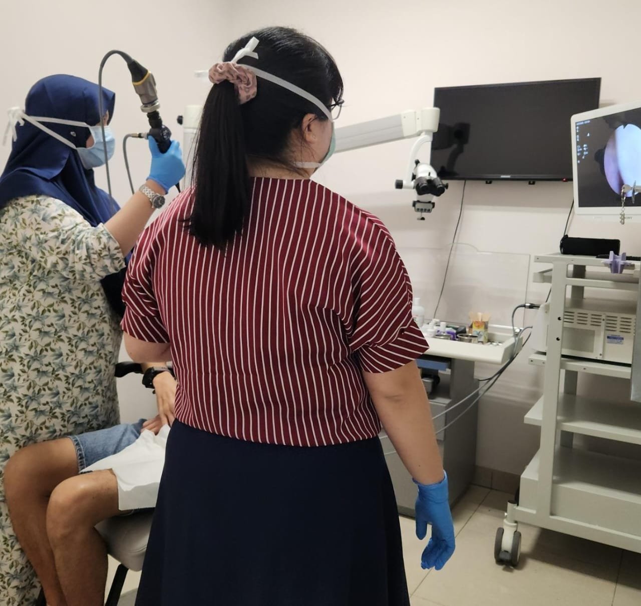Dr. Yasmin carrying out an ENT endoscopy assessment in clinic